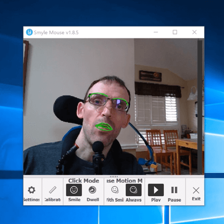 Screenshot of a man in wheelchair using Smyle Mouse to control his computer